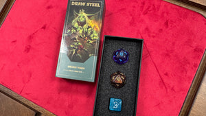 Two dice with game-themed packaging on a red surface